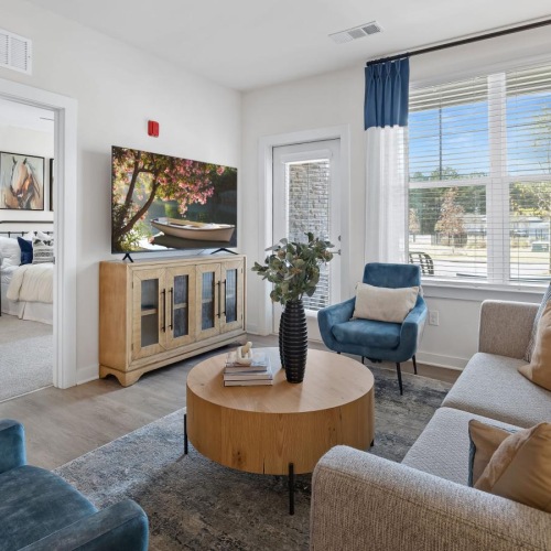 a living room with tall ceilings and natural lighting