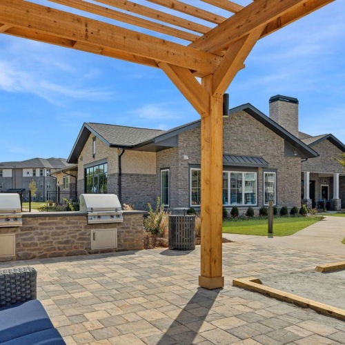 a covered patio and a grilling area