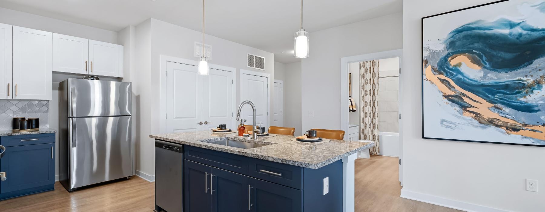 a kitchen with a large painting on the wall